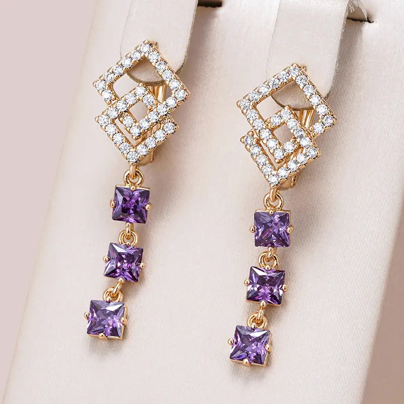Earrings with purple crystals in gold color
