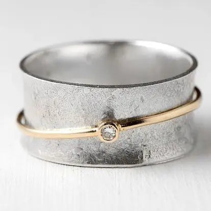 Silver ring with zircons in gold color